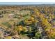 An aerial view showcases nearby park, complete with fields, mature trees, and walking paths at 2602 S Kearney St, Denver, CO 80222