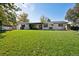 Expansive backyard with lush lawn and a charming white brick home, perfect for outdoor activities and relaxation at 2602 S Kearney St, Denver, CO 80222