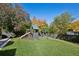 Spacious backyard featuring a well-maintained lawn, a modern playset, and privacy fencing at 2602 S Kearney St, Denver, CO 80222