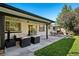 Relaxing backyard patio featuring comfortable seating, a dining set, and a well-maintained lawn with leafy trees at 2602 S Kearney St, Denver, CO 80222