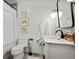 Classic bathroom with a white pedestal sink, black framed mirror, and a shower-tub combination at 2602 S Kearney St, Denver, CO 80222