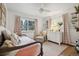 Bedroom featuring bright window, pink accents, chair, and hardwood floors at 2602 S Kearney St, Denver, CO 80222