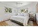 Bedroom features a large bed with white bedding, bright windows, and hardwood floors at 2602 S Kearney St, Denver, CO 80222