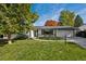 Charming single-story home with a well-manicured lawn, mature trees, and a two-car garage at 2602 S Kearney St, Denver, CO 80222