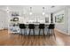 Modern kitchen with an island featuring bar stool seating, white cabinets, and stainless steel appliances at 2602 S Kearney St, Denver, CO 80222