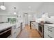 Bright kitchen featuring a large island, stainless steel appliances, and white subway tile backsplash at 2602 S Kearney St, Denver, CO 80222