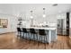 Stylish kitchen island with bar stool seating, updated appliances, and pendant lighting fixtures at 2602 S Kearney St, Denver, CO 80222