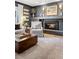 Cozy living room with a brick fireplace, wood floors, and decorative art pieces above the mantle at 2602 S Kearney St, Denver, CO 80222