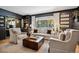 Bright living room featuring neutral furniture, dark accent walls, and a large window with natural light at 2602 S Kearney St, Denver, CO 80222