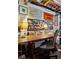 Organized work area with custom shelves, decor, and a large wooden desk beneath exposed basement plumbing at 2602 S Kearney St, Denver, CO 80222