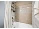 Bathtub with decorative backsplash, mounted shower head, and white shower curtain at 444 17Th St # 807, Denver, CO 80202
