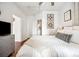 Spacious bedroom with white walls, hardwood floors, a walk in closet, and modern decor at 444 17Th St # 807, Denver, CO 80202