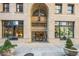 Elegant Midland Lofts entrance featuring an arched doorway, glass doors, and decorative planters adding charm to the façade at 444 17Th St # 807, Denver, CO 80202