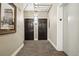 Hallway with wall art, a black door, carpets, and unit number at 444 17Th St # 807, Denver, CO 80202