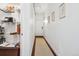 Hallway with art, a light fixture, a white door, pantry, and wood floors at 444 17Th St # 807, Denver, CO 80202