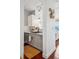 Cozy kitchen with gray cabinetry, stainless steel appliances, and an adjacent hardwood floor hallway at 444 17Th St # 807, Denver, CO 80202