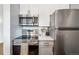 Modern kitchen features stainless steel appliances, white cabinets, and updated countertops at 444 17Th St # 807, Denver, CO 80202