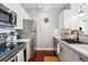 Updated kitchen with stainless steel appliances, granite countertops, and white cabinetry at 444 17Th St # 807, Denver, CO 80202