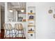 Stylish kitchenette with bar seating, floating shelves, and modern pendant lighting at 444 17Th St # 807, Denver, CO 80202