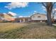 Spacious backyard featuring a patio and large lawn, perfect for outdoor activities at 10636 Ura Ln, Northglenn, CO 80234