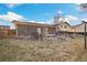 Backyard features a brick patio, grass area and a wooden fence at 10636 Ura Ln, Northglenn, CO 80234