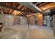 Spacious unfinished basement features exposed ceiling beams and concrete flooring at 10636 Ura Ln, Northglenn, CO 80234