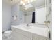 Bright bathroom with vanity with a large mirror and a shower behind a curtain at 10636 Ura Ln, Northglenn, CO 80234