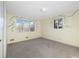Spacious bedroom features neutral carpet, light walls and two large windows at 10636 Ura Ln, Northglenn, CO 80234