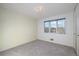 Cozy bedroom with large windows, soft carpet and neutral walls at 10636 Ura Ln, Northglenn, CO 80234