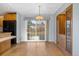 Bright dining area features wood floors, chandelier, and sliding glass doors to backyard at 10636 Ura Ln, Northglenn, CO 80234