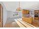 Sun-filled kitchen featuring wooden cabinets and an island with an electric cooktop at 10636 Ura Ln, Northglenn, CO 80234