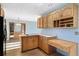 Bright kitchen featuring wooden cabinets, and a wooden desk at 10636 Ura Ln, Northglenn, CO 80234
