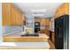Kitchen with wooden cabinets, stainless steel appliances, and bright skylights at 10636 Ura Ln, Northglenn, CO 80234