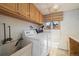 Functional laundry room with a sink, washer and dryer and storage cabinets at 10636 Ura Ln, Northglenn, CO 80234