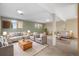Spacious living room has multiple seating areas and multiple windows at 10636 Ura Ln, Northglenn, CO 80234