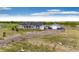 Aerial view of a well maintained property, featuring a house, outbuilding and expansive landscape at 196 W 8Th Ave, Byers, CO 80103