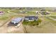 Aerial view of home and shop with nearby homes in rural setting, featuring fields and open space at 196 W 8Th Ave, Byers, CO 80103