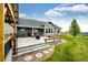 Beautiful backyard boasts a covered patio, lush lawn, and mature landscaping, creating a tranquil outdoor oasis at 196 W 8Th Ave, Byers, CO 80103
