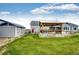 Well-maintained backyard with a spacious lawn, wooden gazebo, and sheds, offers ample space for outdoor activities at 196 W 8Th Ave, Byers, CO 80103
