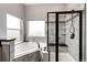 Elegant bathroom with separate tub and glass-enclosed shower with tiled walls at 196 W 8Th Ave, Byers, CO 80103