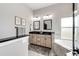 Bright bathroom featuring dual sinks, granite counters, and a soaking tub at 196 W 8Th Ave, Byers, CO 80103