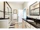 Bright bathroom with glass enclosed shower, granite vanity, and neutral tones at 196 W 8Th Ave, Byers, CO 80103