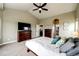 Bedroom featuring vaulted ceiling, large window, and wood furniture at 196 W 8Th Ave, Byers, CO 80103