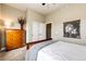 Cozy bedroom features a wooden dresser, neutral paint, and simple decor, creating a peaceful atmosphere at 196 W 8Th Ave, Byers, CO 80103