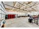 Vast garage featuring bright lighting, high ceilings, storage, and ample workspace for projects and parking at 196 W 8Th Ave, Byers, CO 80103