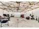 Large garage space with abundant lighting, storage, a sink, and doors, offering versatile use and functionality at 196 W 8Th Ave, Byers, CO 80103