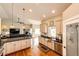 Modern kitchen featuring light cabinetry, stainless steel appliances, and an open layout to the living area at 196 W 8Th Ave, Byers, CO 80103