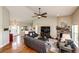 Open-concept living room with fireplace, hardwood floors, and ample seating at 196 W 8Th Ave, Byers, CO 80103