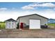Spacious metal outbuilding with garage door and shed provides ample storage and workspace on a gravel lot at 196 W 8Th Ave, Byers, CO 80103