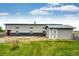 Large metal outbuilding with dual-tone siding and ample yard space offers potential for storage or a workshop at 196 W 8Th Ave, Byers, CO 80103